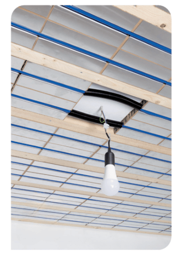 Installed Circutherm water-based ceiling heating and cooling system with blue pipework and timber battens