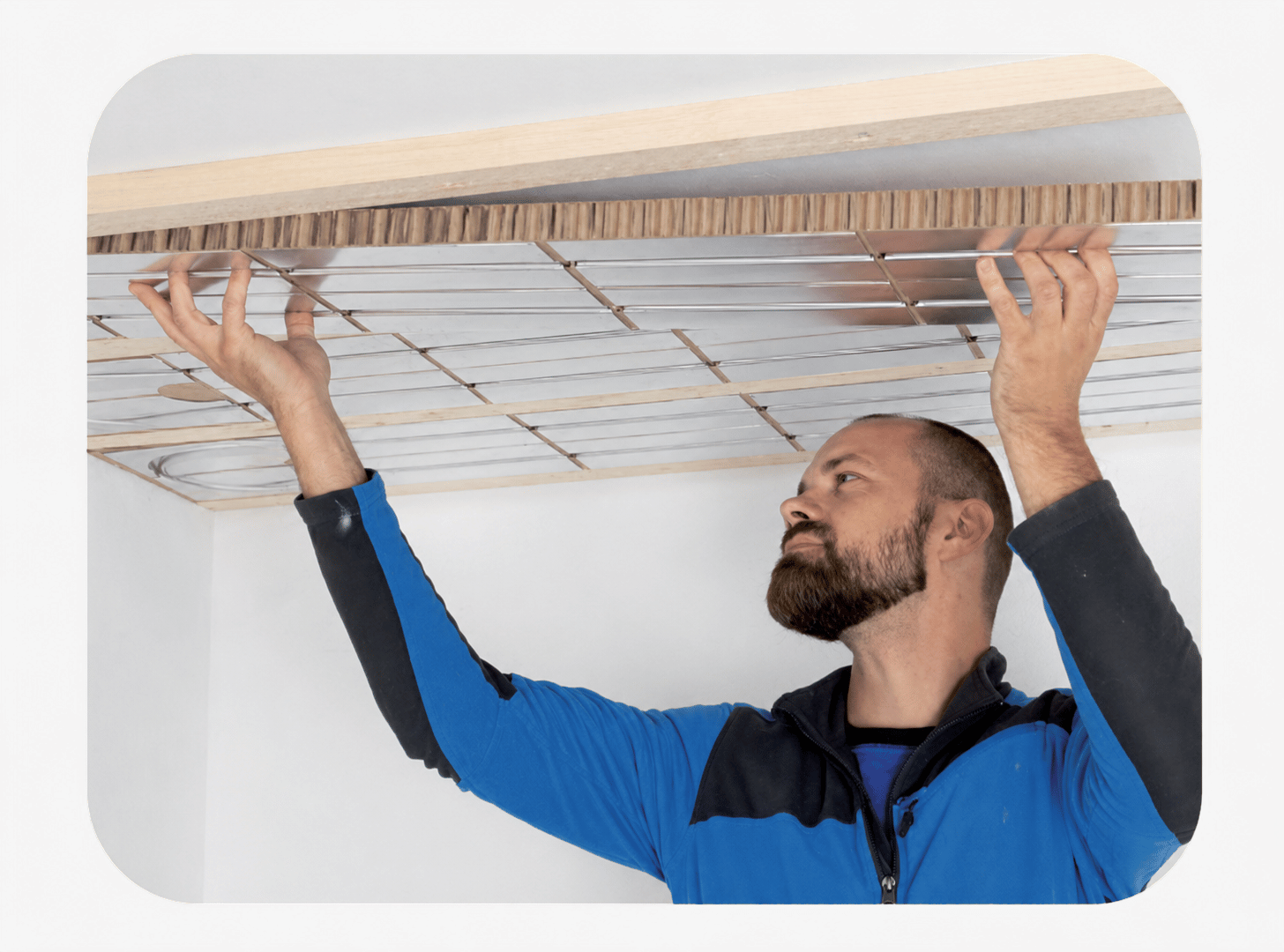 Installer fitting IDEAL Classic CAB 30 recycled paper ceiling heating panels
