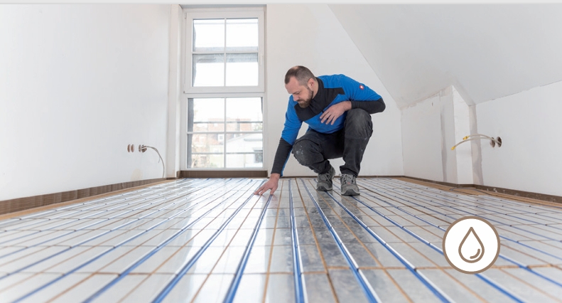 UK heating installer fitting a low-profile water-based surface heating system